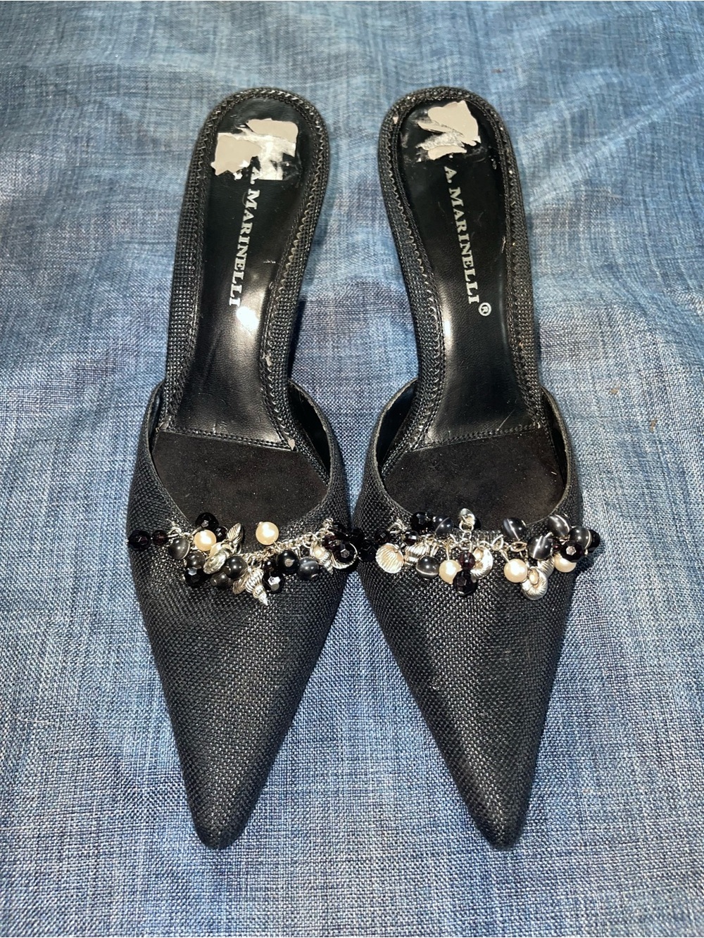A. Marinelli black pointed-toe mules with shell charm